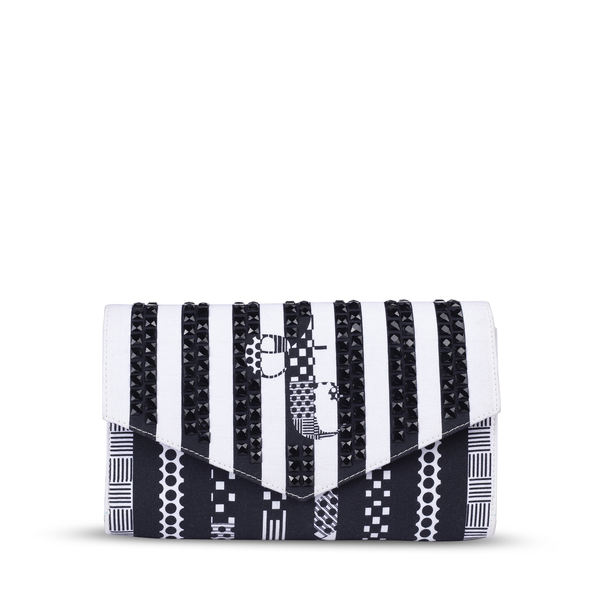 Woman posing with a black and white striped clutch featuring bold geometric patterns, styled for a chic modern look