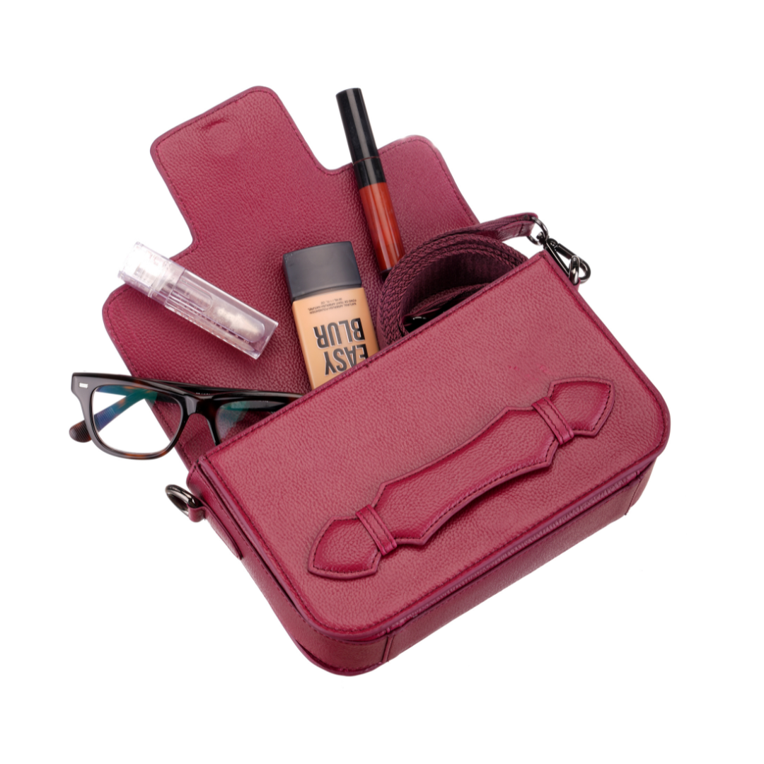 Etcetera Markcross crossbody bag in wine-red leather with flap and wide adjustable strap in matching burgundy.